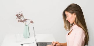 Woman in Pink Dress Using Laptop Computer